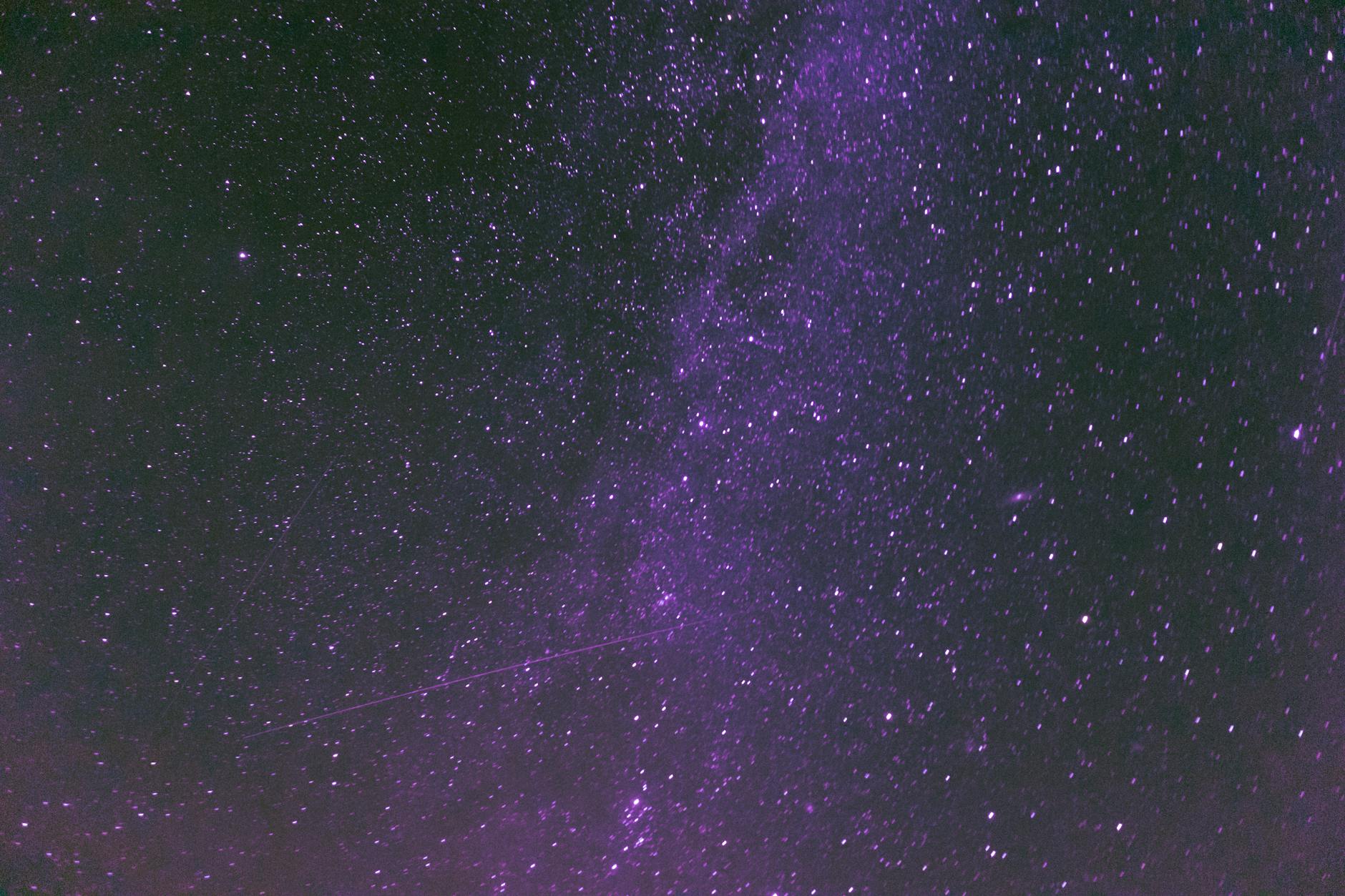 The cosmic energy of angel number 855 — deep purple galaxy light representing the abundance and transformation this number brings
